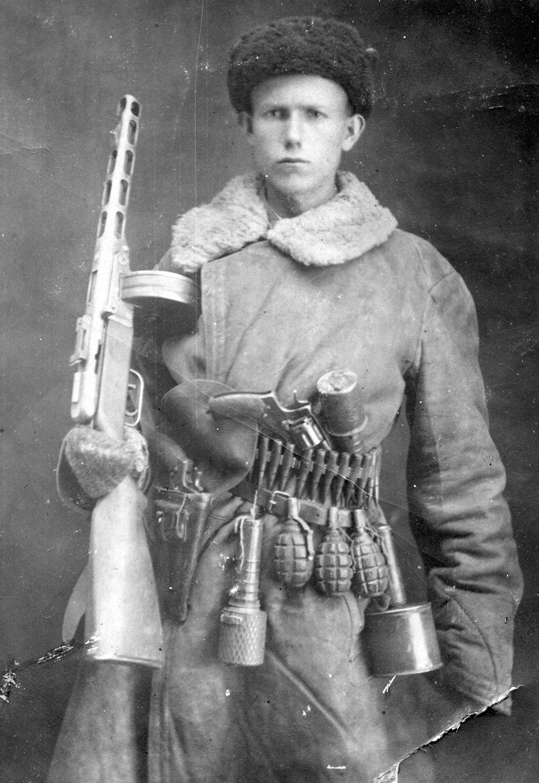 Russian soldier armed to the teeth (PPSh-41, 1895 Nagant, hand grenades)