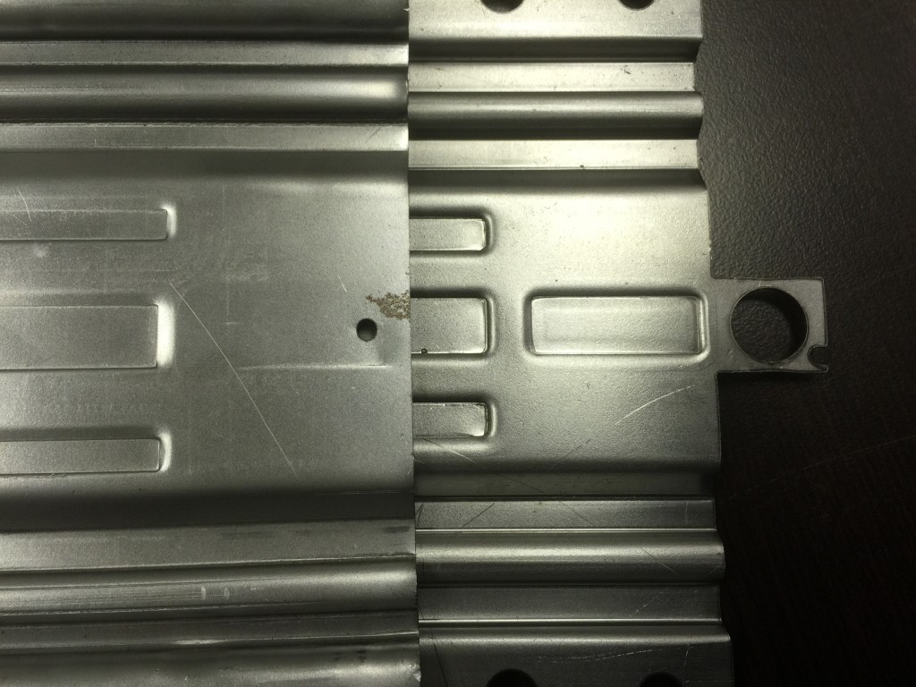 Proxies left, HMG right. The Prexis locating hole is inside the receiver material, while HMG's is an extensions trimmer off after bending, which does not leave a hole in the finished product.