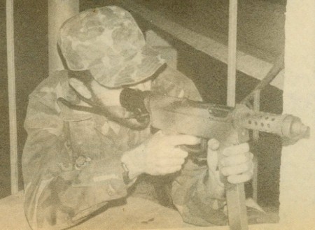 Author firing an Uru SMG from cover