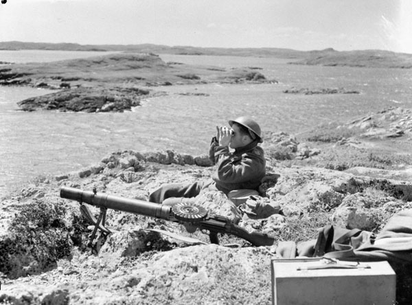 Soldier of the Black Watch guards a beach with a Lewis LMG