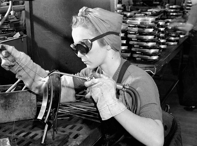 Worker welding a Bren magazine at Inglis