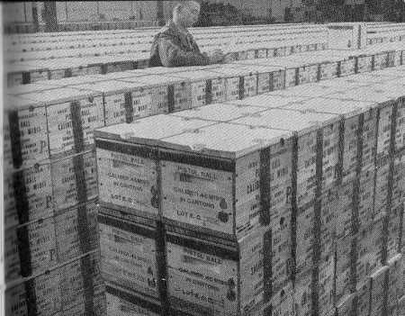 Inspector checking part of a day's .45ACP production from Evansville, early in WWII