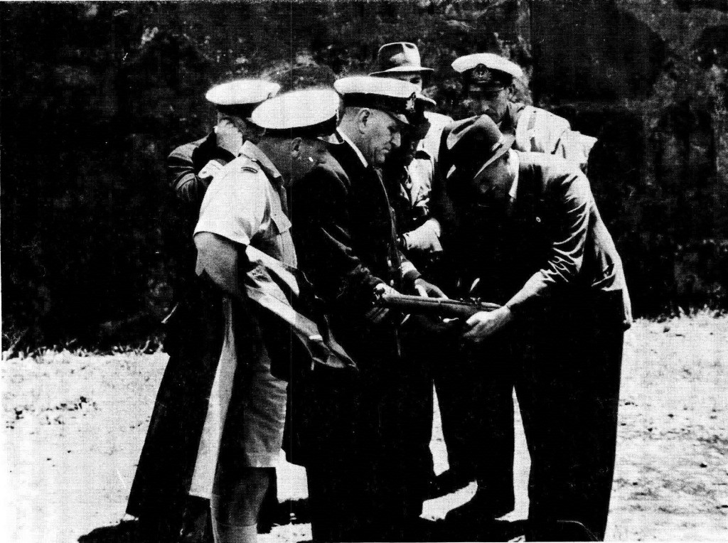 Mr Rieder shows his invention to Royal Naval officers, an army officer and a civilian after a demonstration outside the Castle in Cape Town