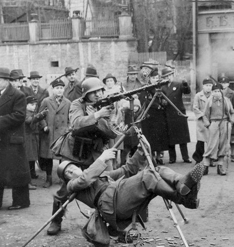 German soldier using his body weight to stabilize an antiircraft machine gun mount