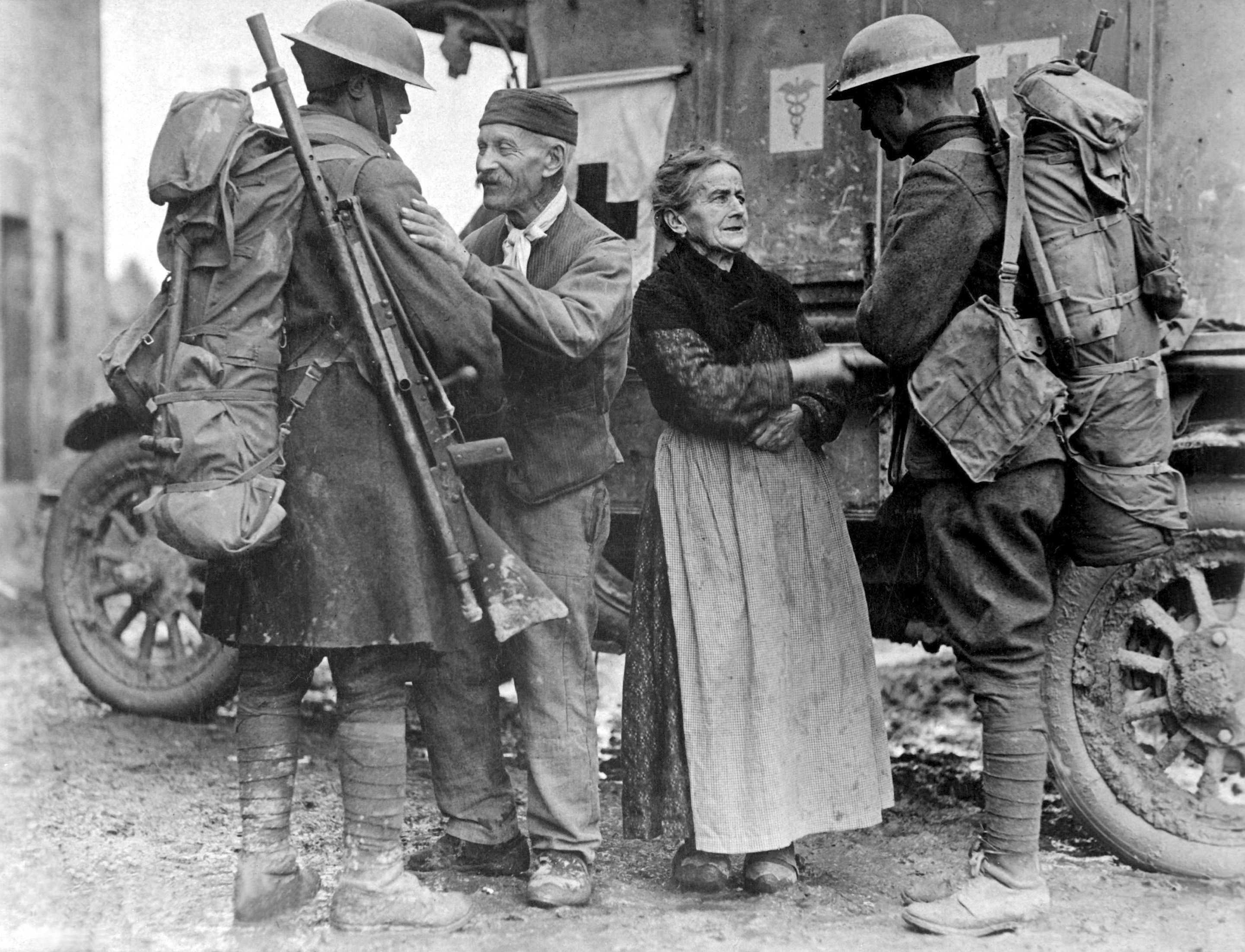 An old  French couple, M. and Mme. Baloux of Brieulles-sur-Bar, France, under German occupation for four years, greeting soldiers of the 308th and 166th Infantries upon their arrival during the American advance.  November 6, 1918. 