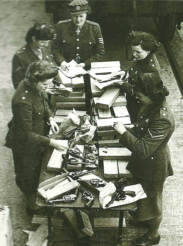 British women sort through guns donated by Americans for the Home Guard.